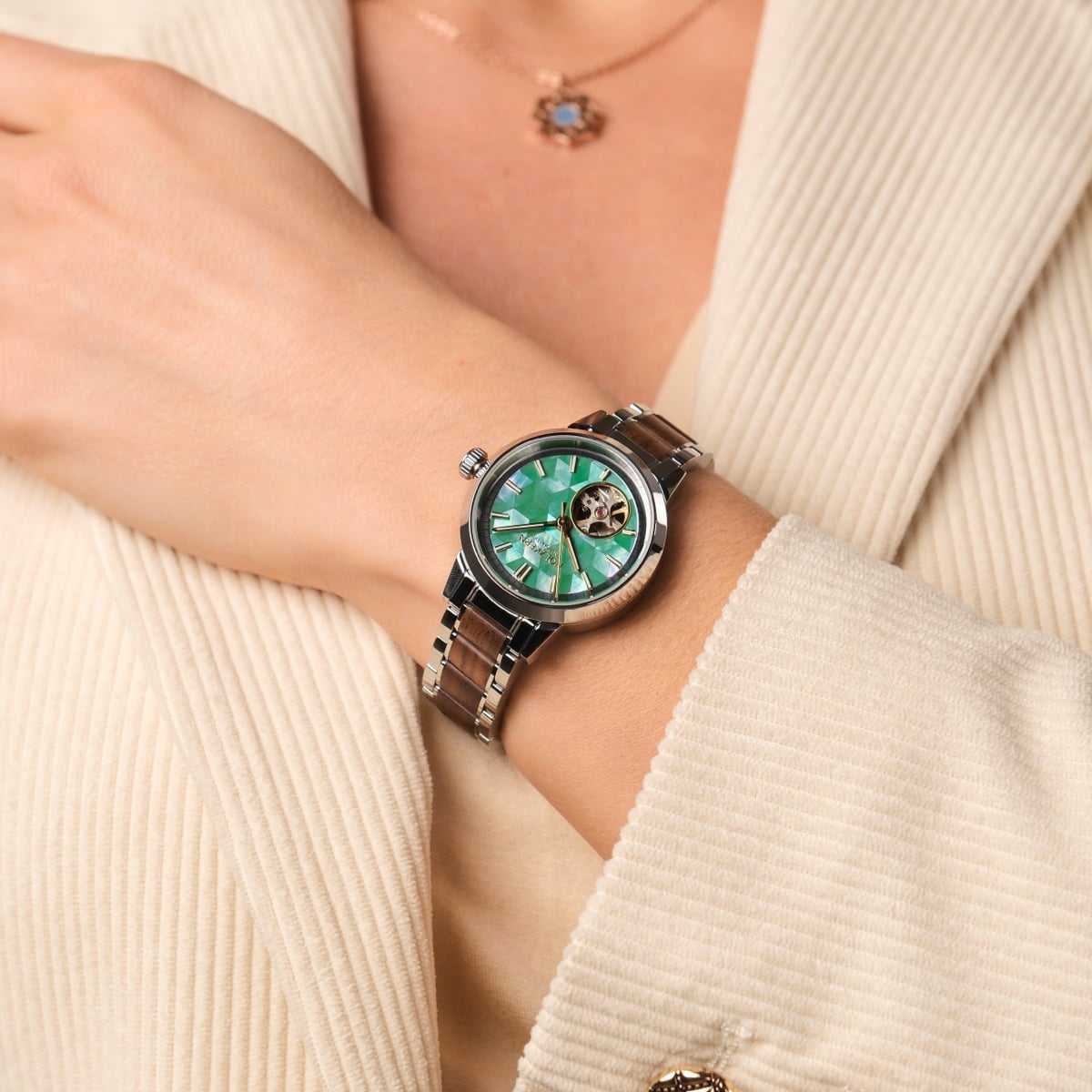 "Colorburst" watch featuring a nacre dial and walnut accents, exuding a stylish and elegant visual appeal.