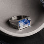 "Binomial Ring" ring featuring a sodalite stone set in silver with a modern, angular design.