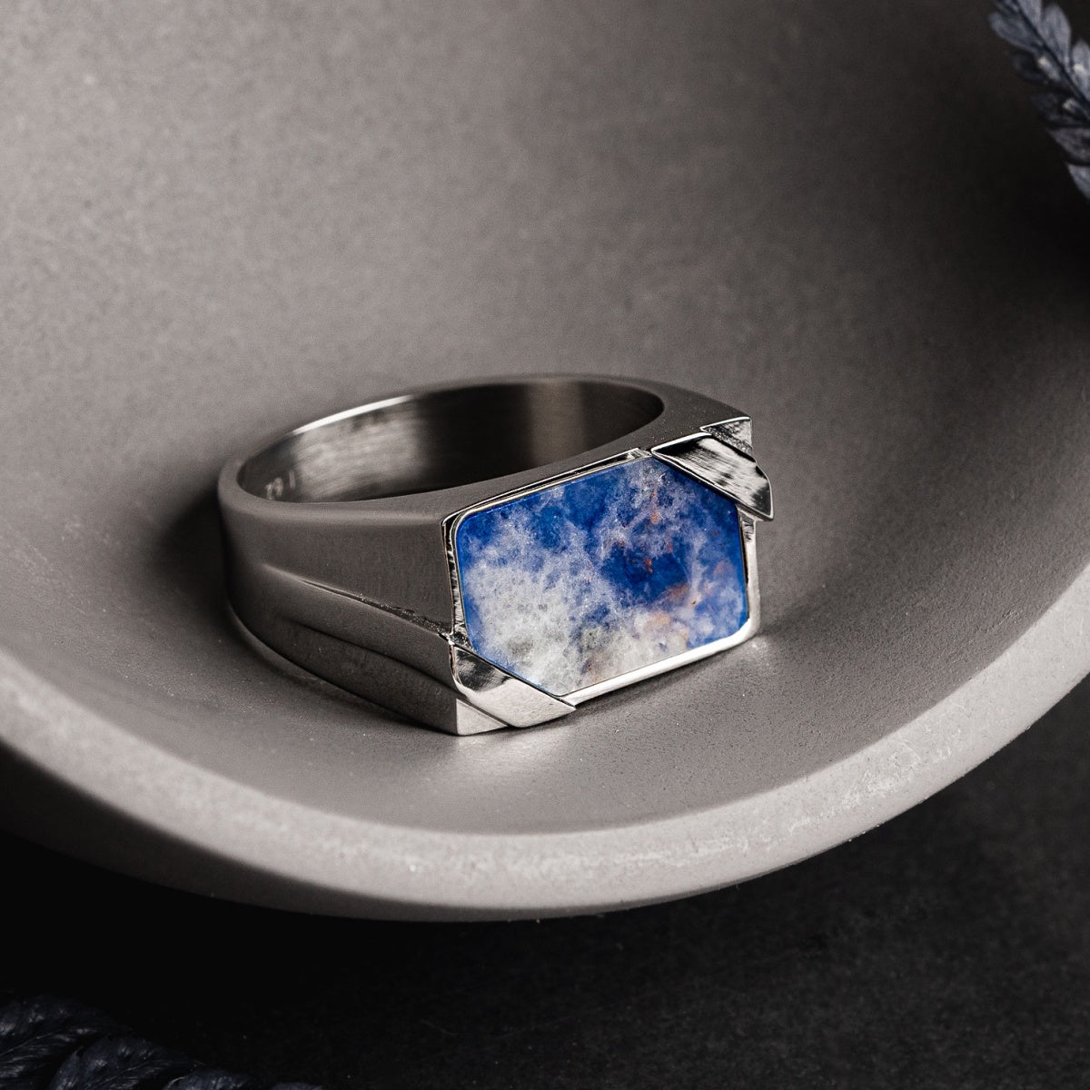"Binomial Ring" ring featuring a sodalite stone set in silver with a modern, angular design.