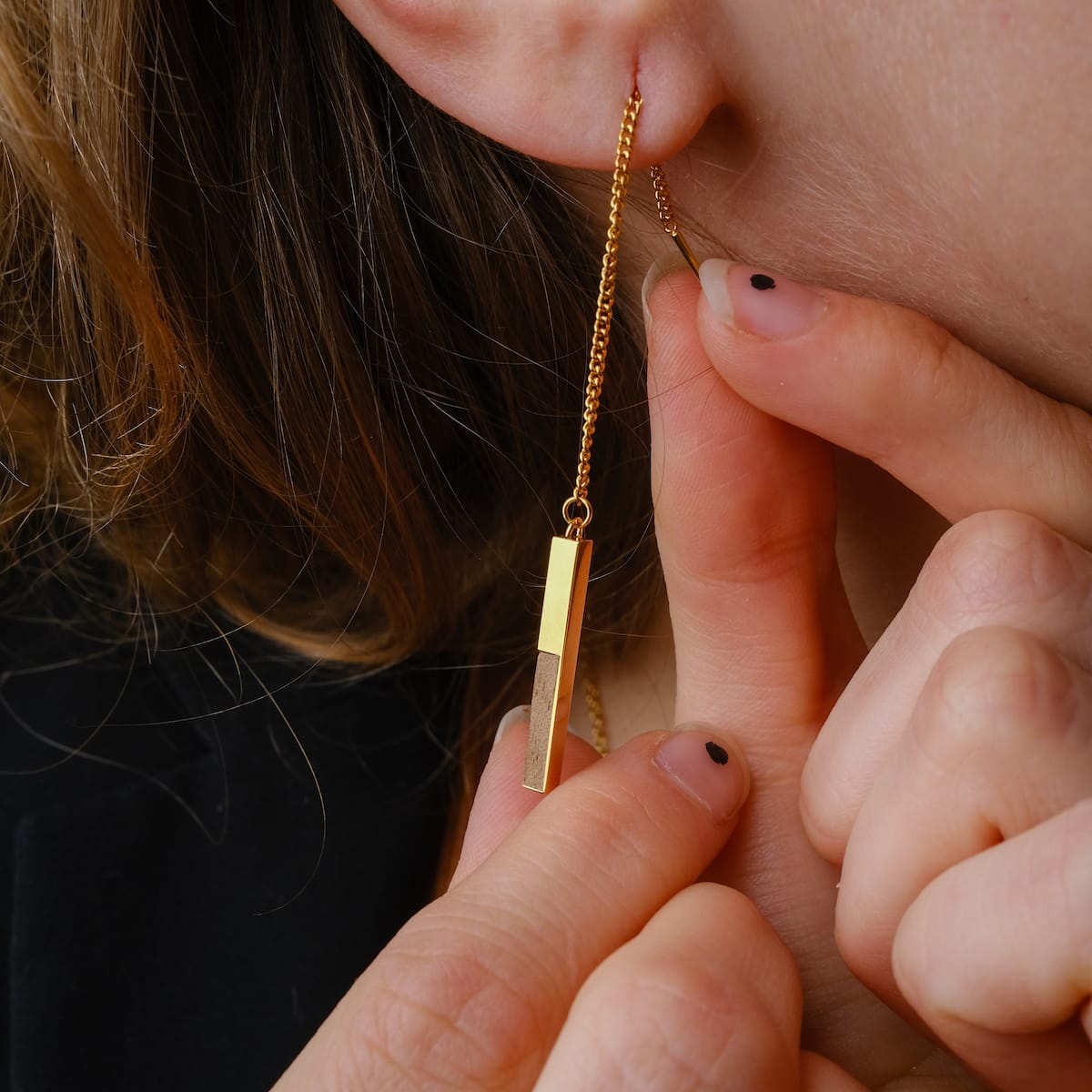 "Campania Earrings" earrings, showcasing a sleek Koa wood and gold design with a minimalist chain style.