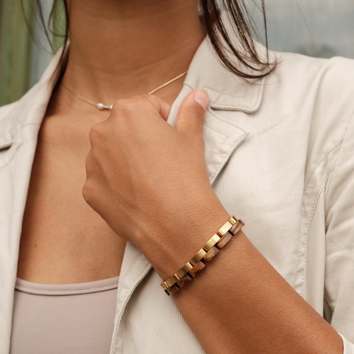 "Duet" bracelet, featuring a sophisticated zebrawood and gold design on a woman's wrist.