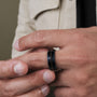Cartesian ring featuring a dark maple and blue design worn on a hand.