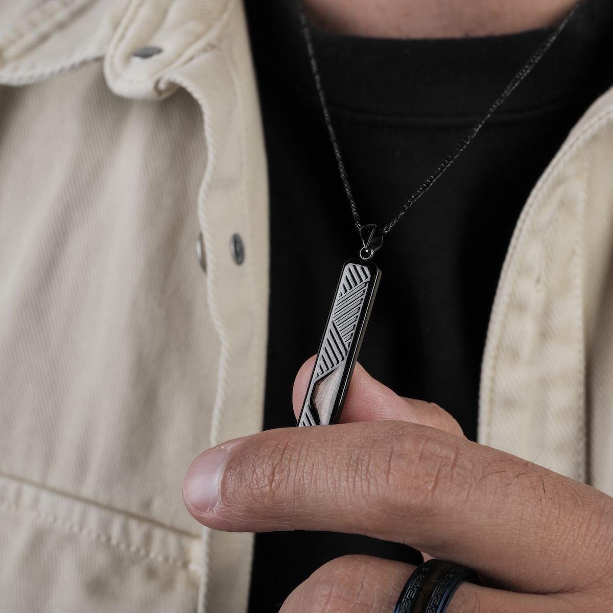 "Derivatives Necklace", a stylish black and zebrawood necklace with a geometric pendant design.