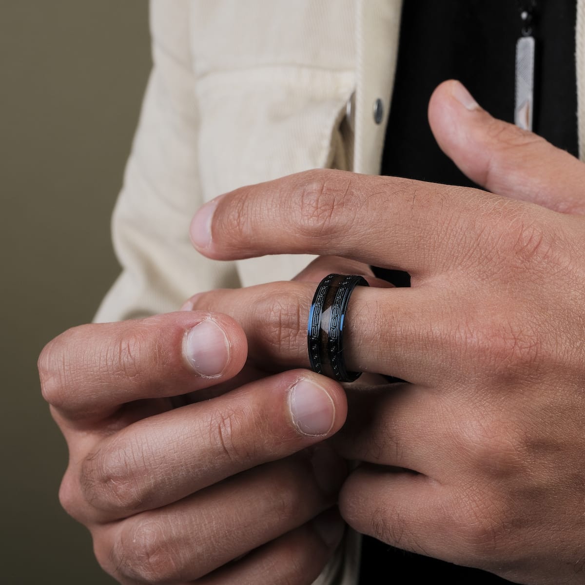 "Numerary Ring" ring with a walnut and blue design, showcasing a sleek and modern style.