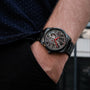 "Pacemaker wristwatch with a marble design and sleek style, featuring a detailed skeletal dial and vibrant red accents."