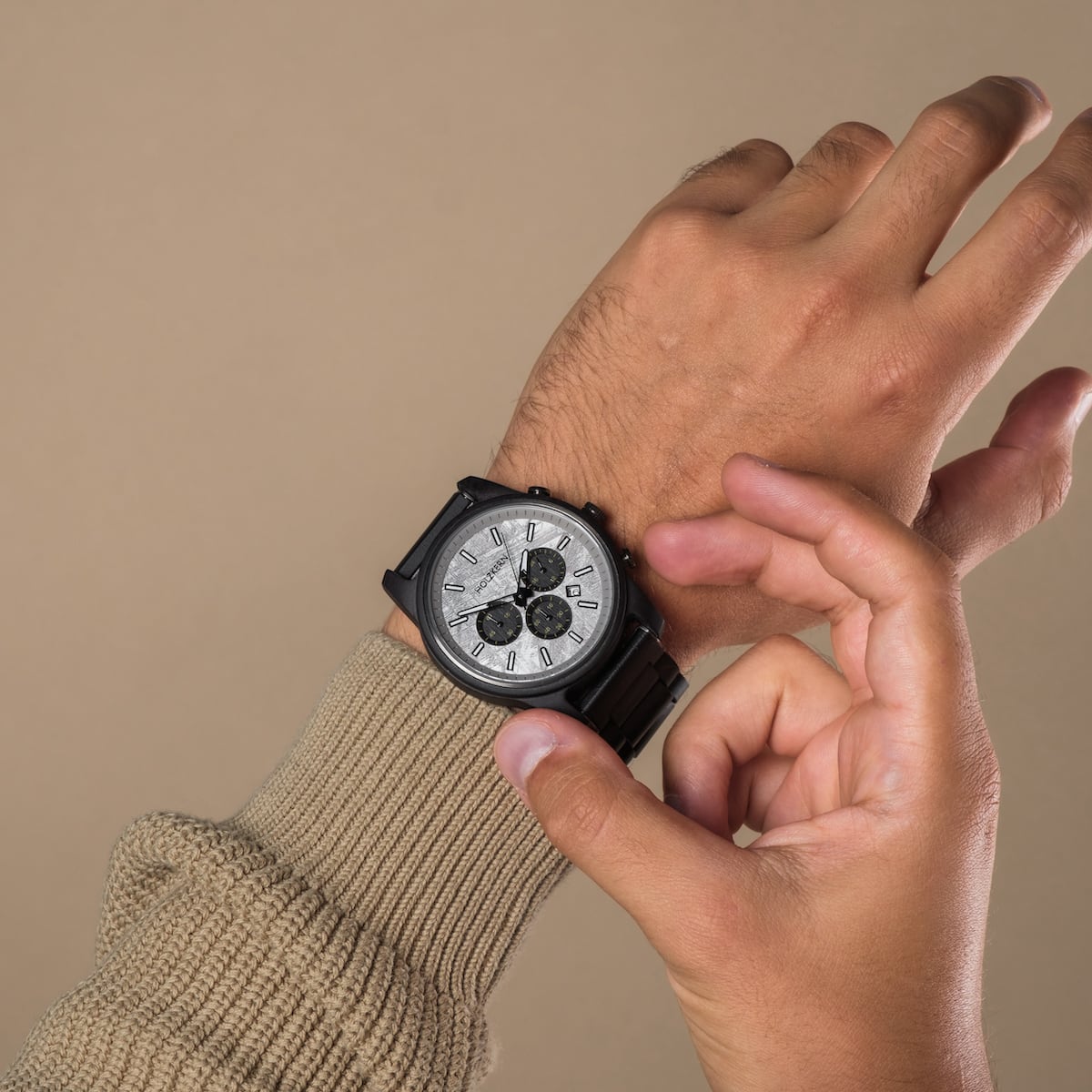 "Northwall" watch, featuring a modern design with a maple and rockgrey finish, worn on a wrist.
