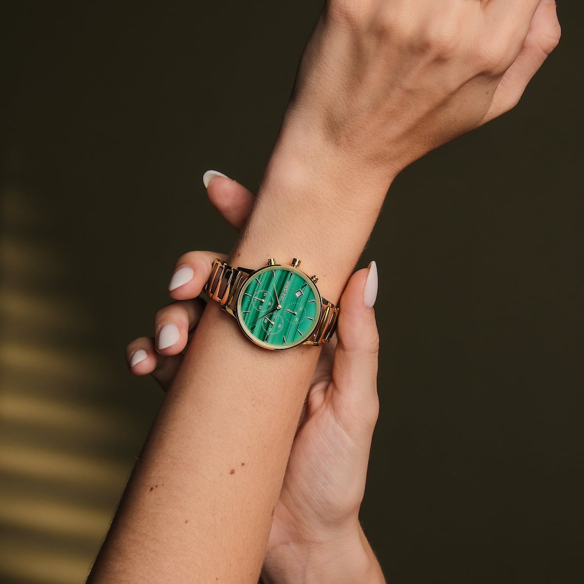 "Jolly" wristwatch with malachite green face and ceramic band, elegant and stylish design.