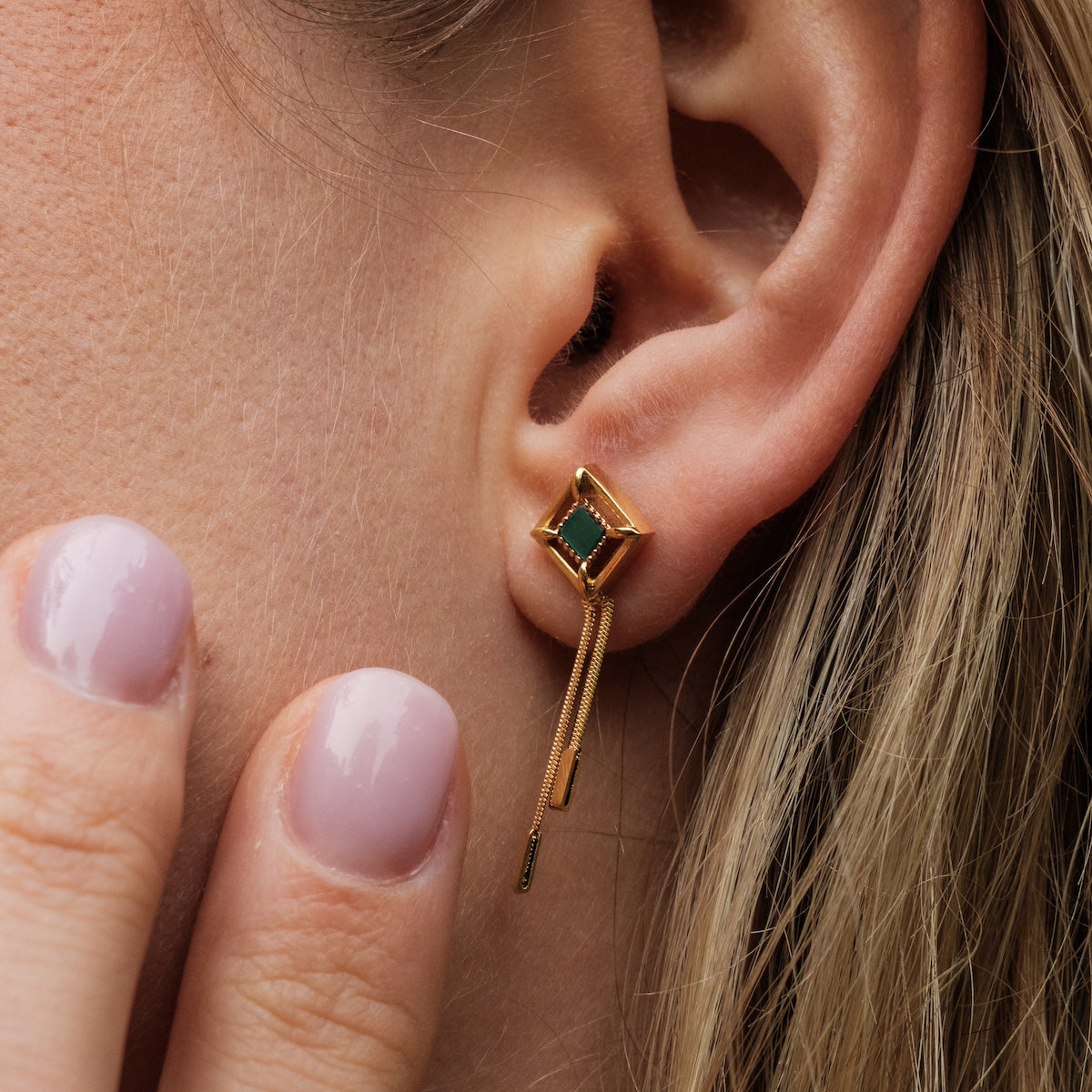 "Awakening earrings" are chic earrings with a marble and gold design, featuring a modern geometric style.