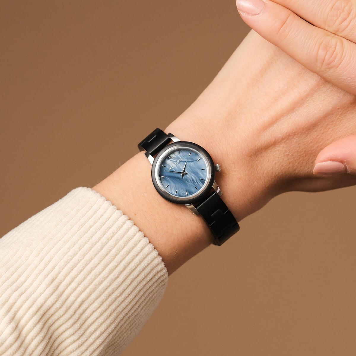"Big Sur" wristwatch featuring a unique maple and nacre design on a sleek band, offering a stylish visual appeal.
