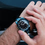 "Glaciersurge" men's watch featuring a sleek design with a dark dial and unique blue metallic accents.