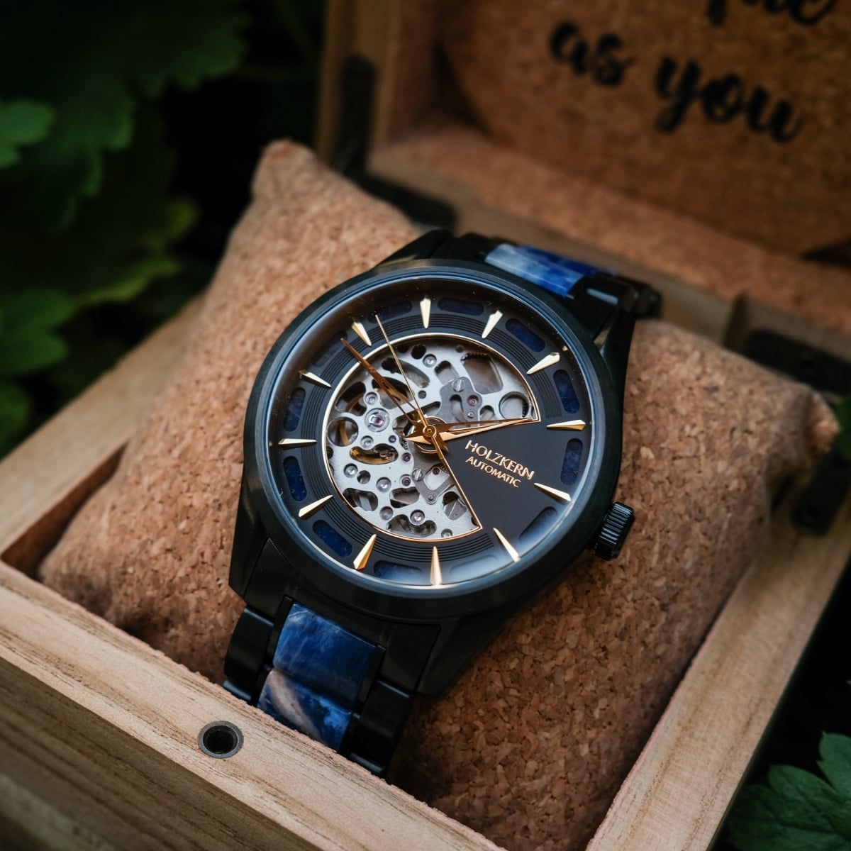 "Vredefort" watch featuring a marble and black design with a skeleton dial and gold accents.