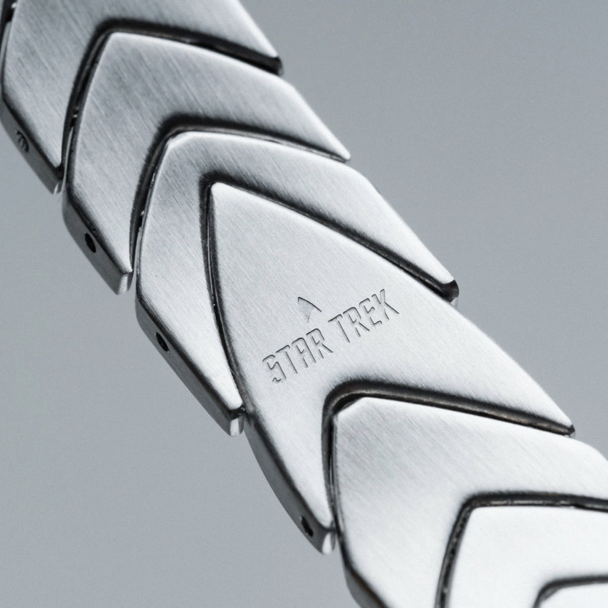 "Operations" bracelet featuring a sleek, silver tone and distinct geometric design.