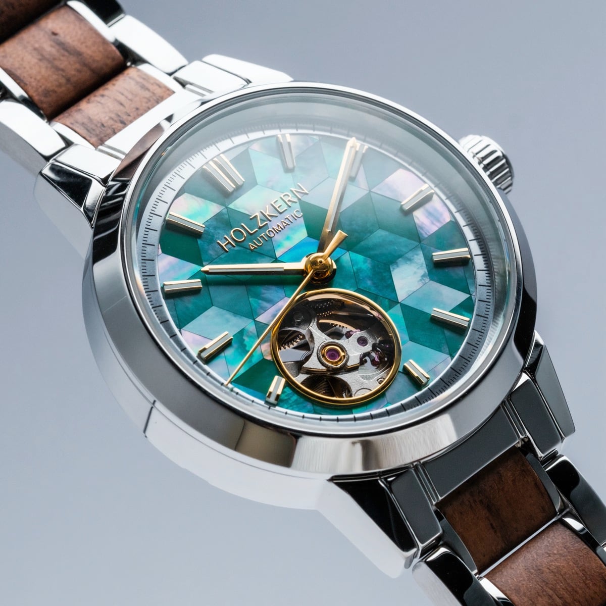 "Colorburst" wristwatch featuring a nacre face and walnut accents with a geometric design.