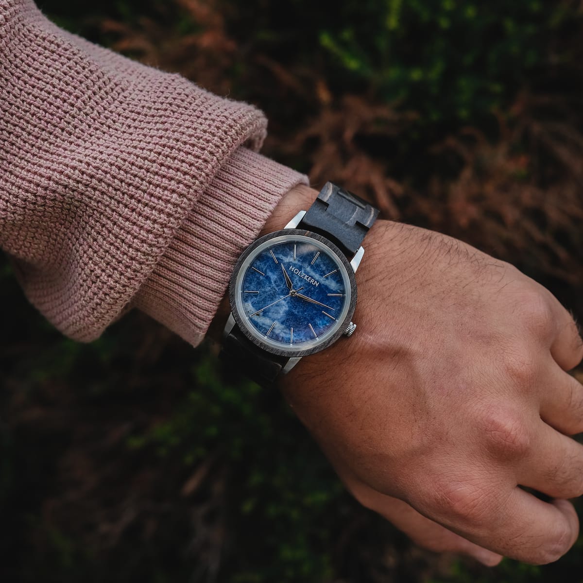 "Immanuel" wristwatch with a sodalite-blue dial and maple accents, worn on a person's wrist.
