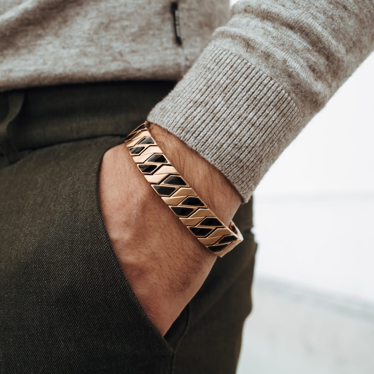 "Baritone" bracelet featuring a sleek maple and gold design, worn casually on the wrist.