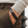 "Baritone" bracelet, featuring a sleek, dark grey geometric design with maple accents.