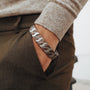 "Baritone" bracelet featuring a Walnut and Silver Chevron design, worn on a wrist in a casual style.