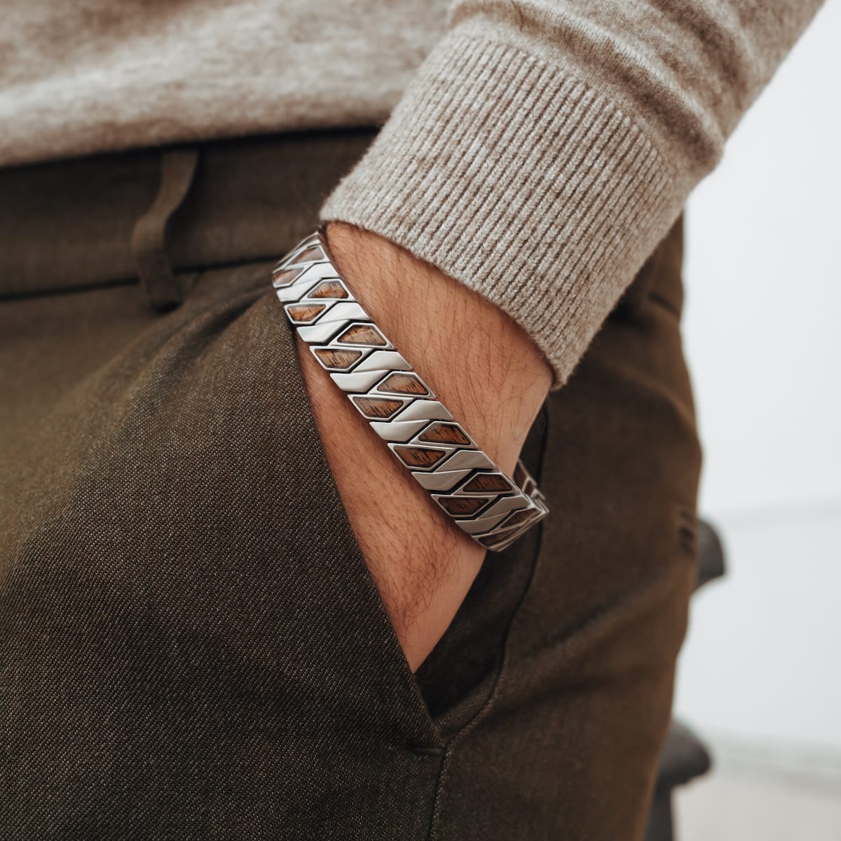 "Baritone" bracelet featuring a Walnut and Silver Chevron design, worn on a wrist in a casual style.