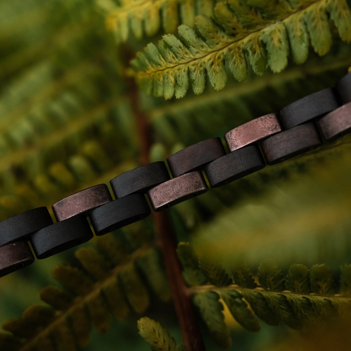 "Rondo" bracelet with a maple and antique copper finish, featuring a natural and earthy design style.