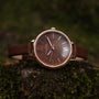 "Shirin" watch in walnut and rose gold with a sleek, elegant design.