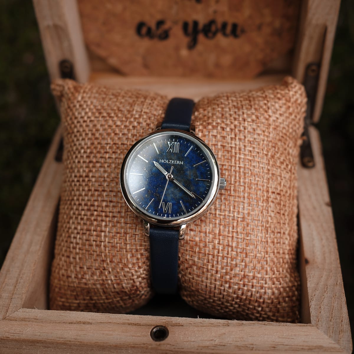 "Teresa" watch featuring a lapis lazuli dial and silver accents with a sleek, elegant design in a wooden box.