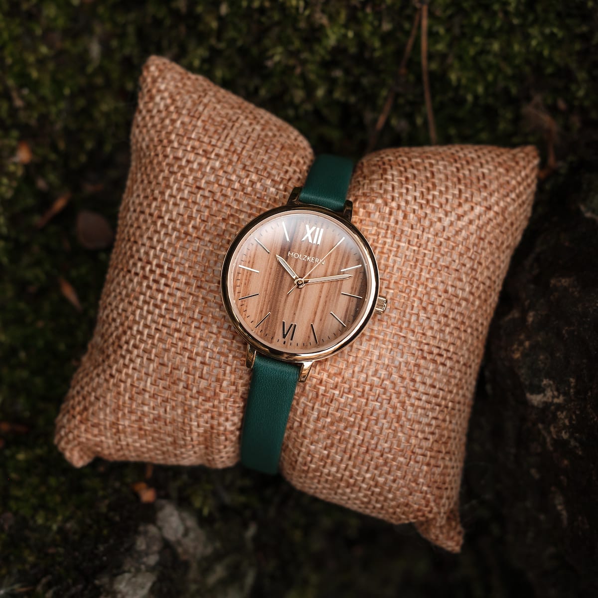 "Wangari" watch featuring zebrawood dial, gold accents, and green strap for an elegant and natural look.
