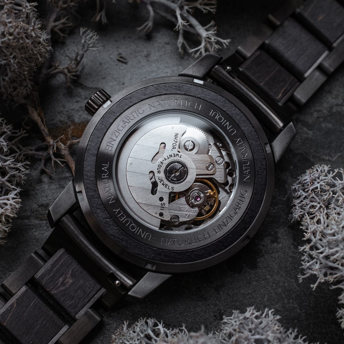 Carbon Wristwatch featuring a dark gray maple finish and intricate mechanical design.