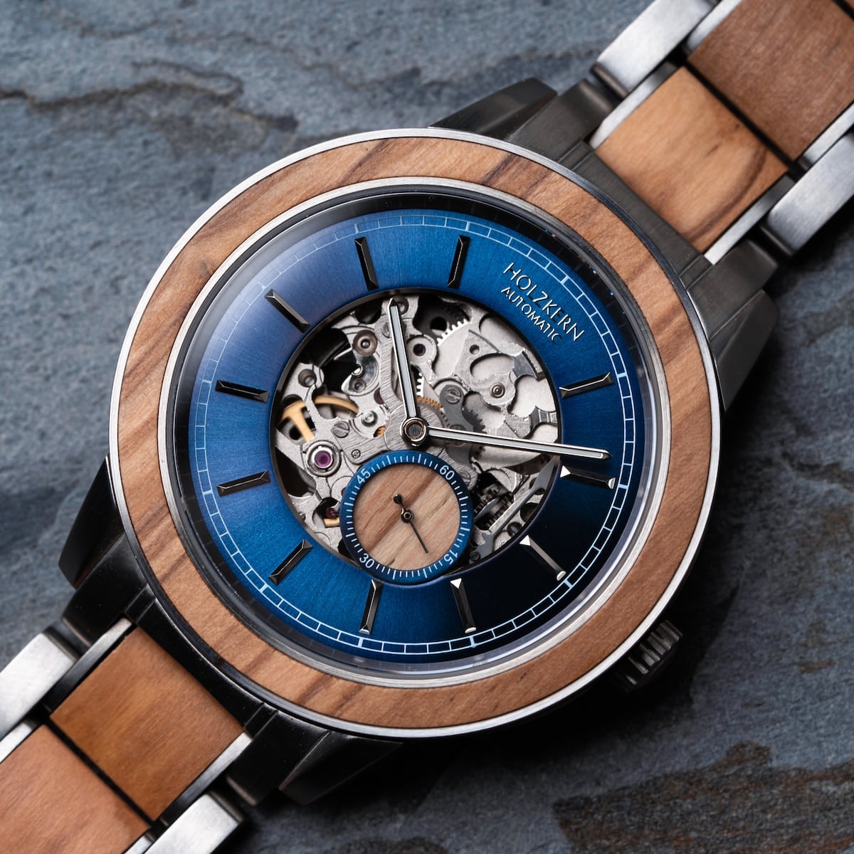 "Haiku" watch with intricate mechanical design, featuring a blue dial and wood accents for an elegant style.