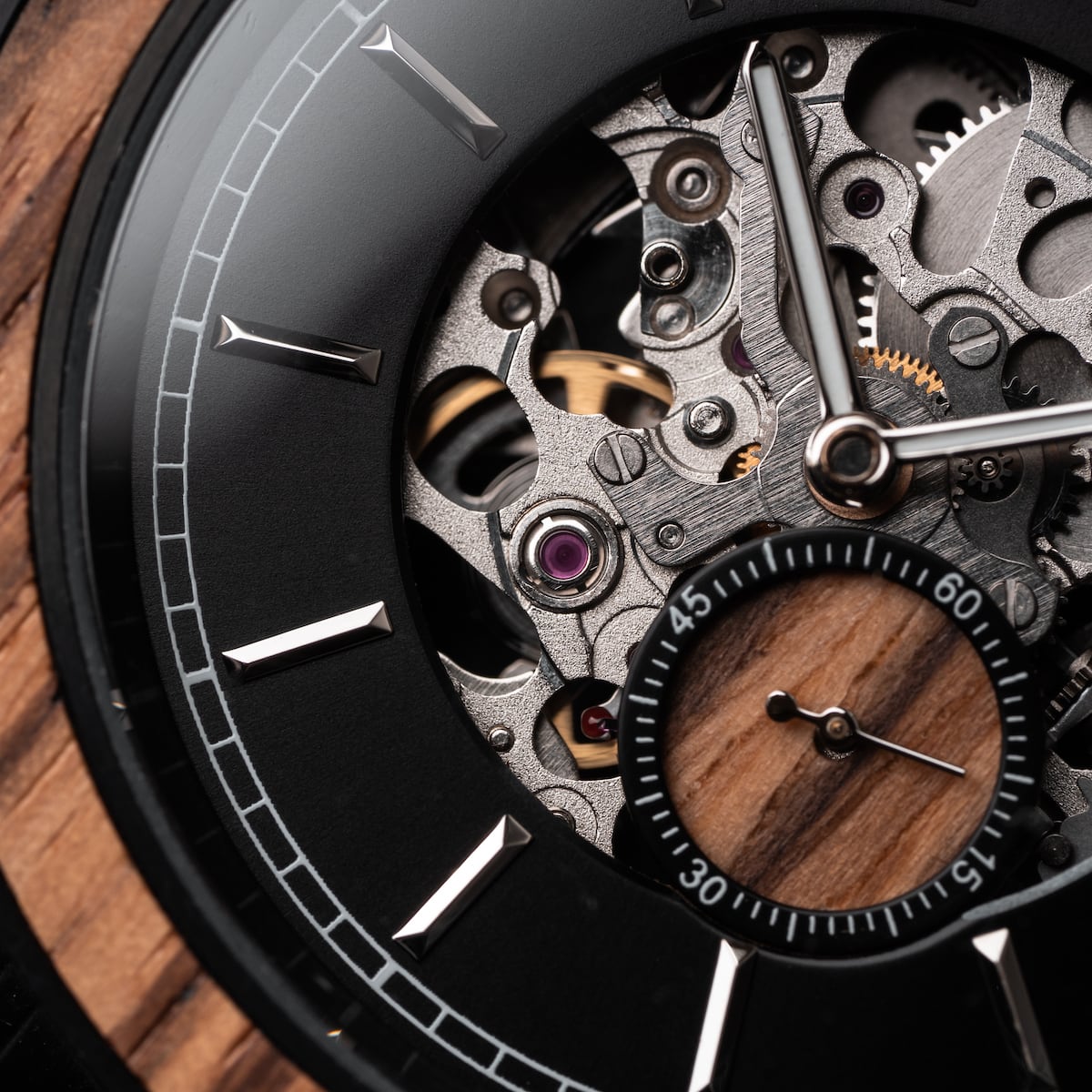 "San Juan" watch features an elegant zebrawood design with a visible mechanical movement.