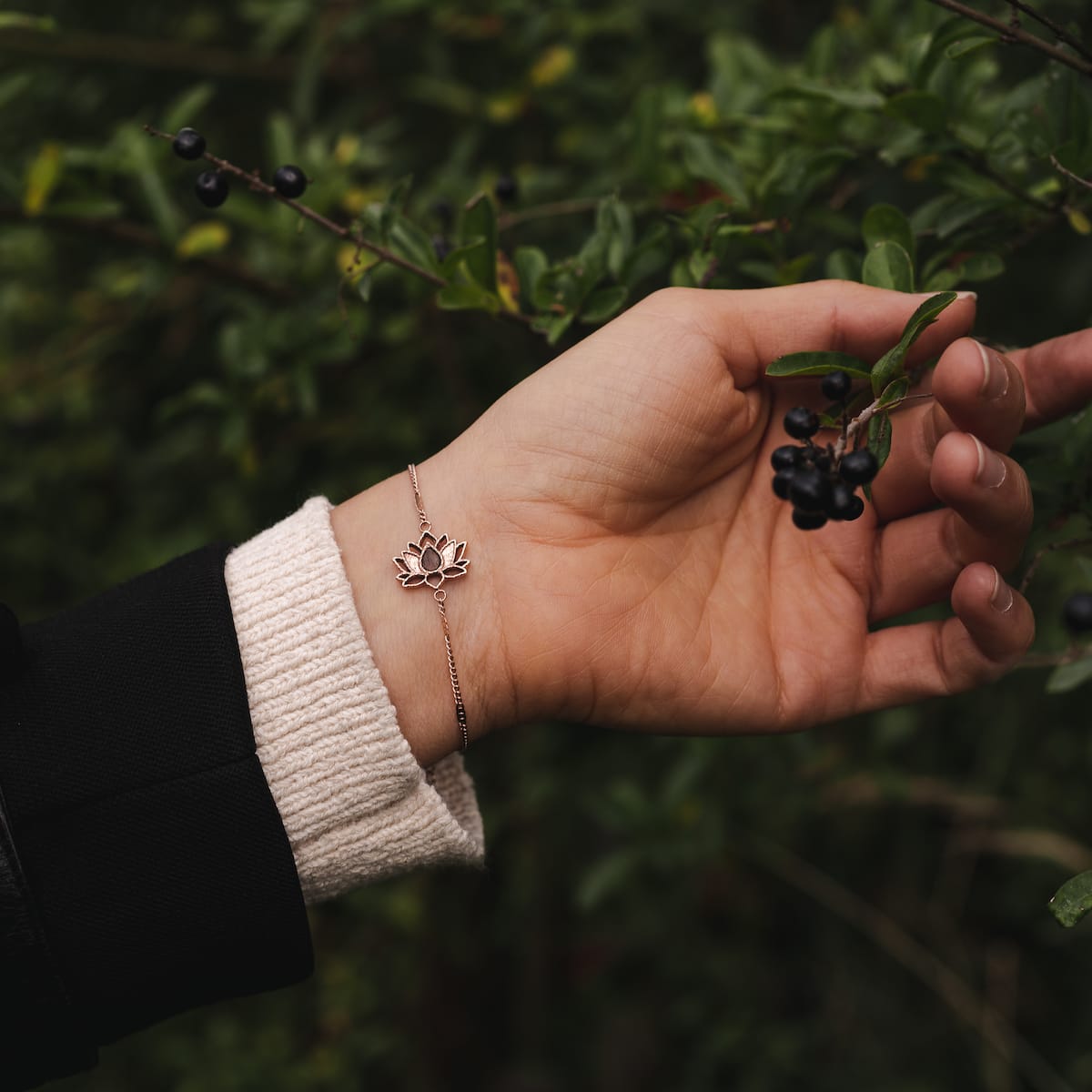 "Balance Bracelet", an elegant bracelet featuring walnut and rose gold tones, worn on a wrist against a natural backdrop.