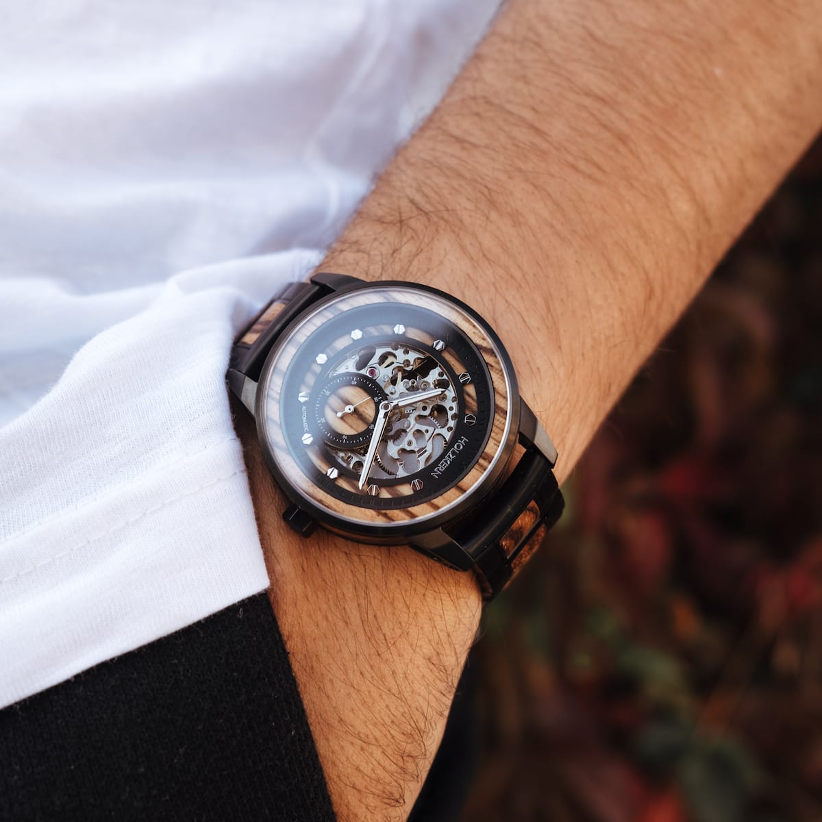 Starrum watch featuring a zebrawood and black design with an intricate, exposed mechanical style.