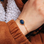 Mirror Bracelet featuring a stylish lapis lazuli stone set in gold with an elegant and minimalist design.