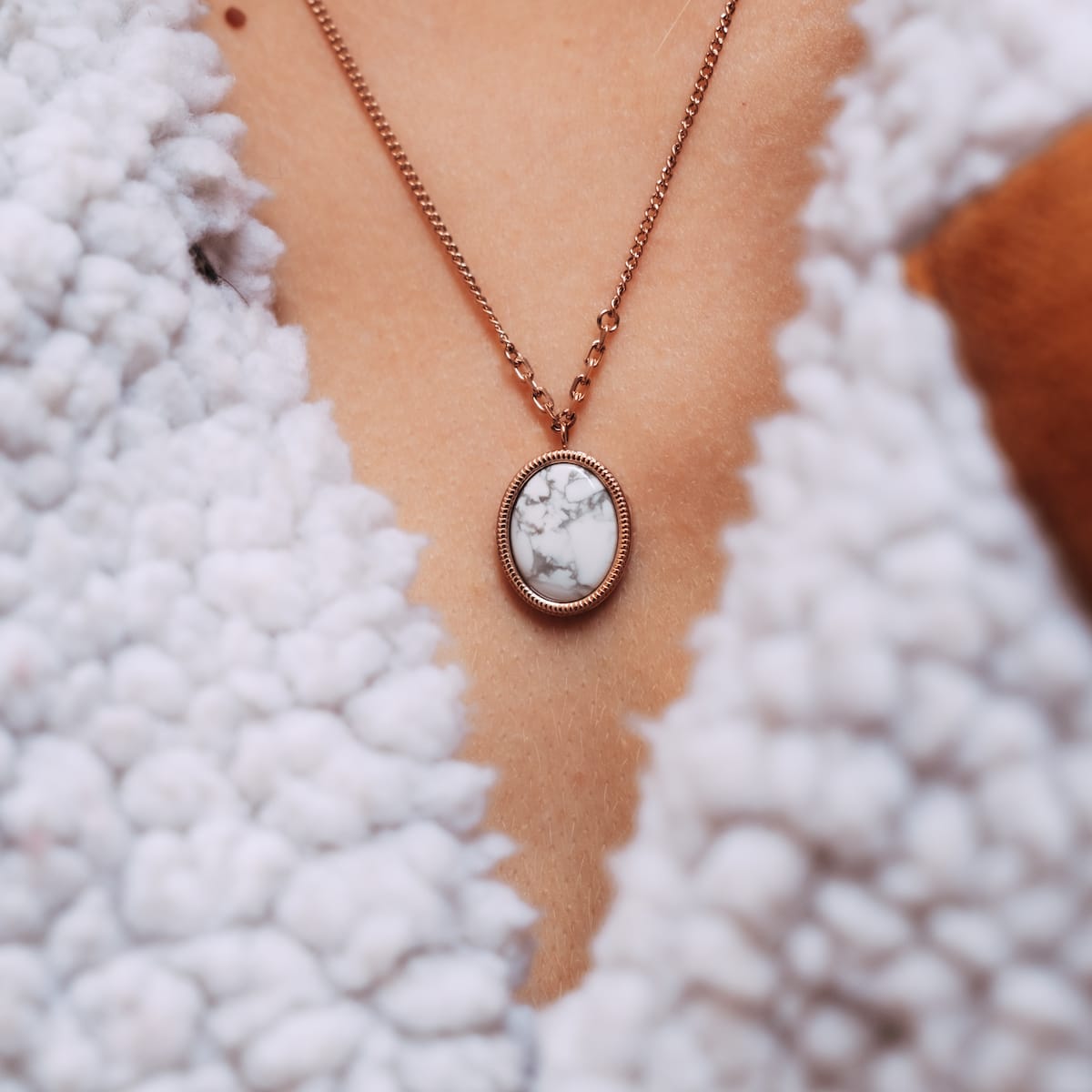 "Mirror Necklace", an elegant necklace featuring a turquoise and rose gold design with a stylish counterpart.