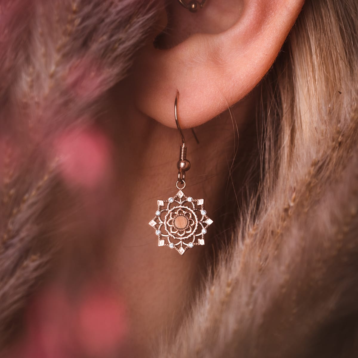 "Aphonia Earrings" features elegant earrings with an intricate design in olive and rose gold tones.