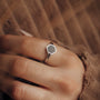 "Facade Ring": A sleek marble and silver hexagonal ring with a minimalist design.