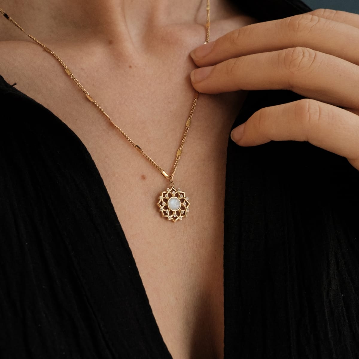 "Composition Gem Necklace": elegant moonstone and gold necklace with intricate pendant design.