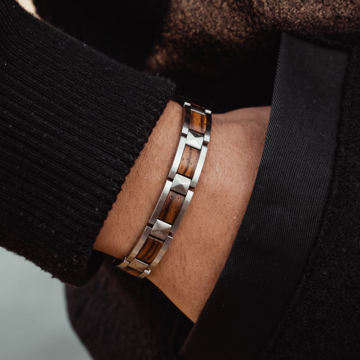 "Rhapsody" bracelet featuring zebrawood and silver accents in a sleek, modern style.