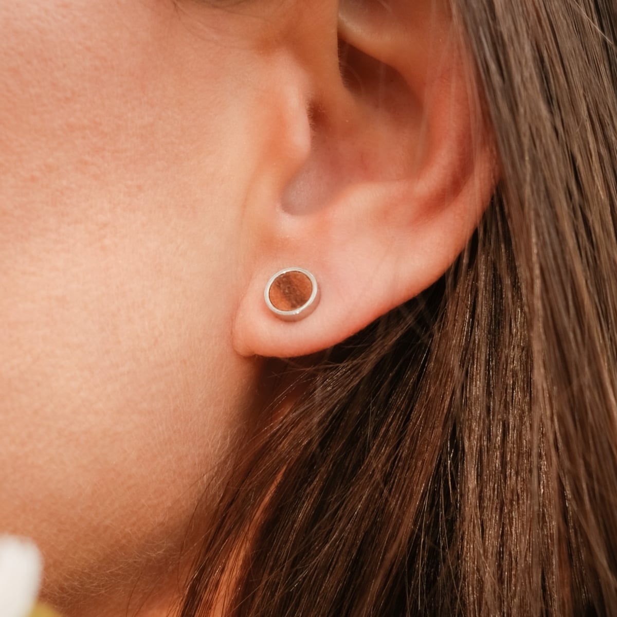 "Pigment Earrings" earrings, featuring a natural koa wood center encased in a sleek silver circle for a minimalist look.