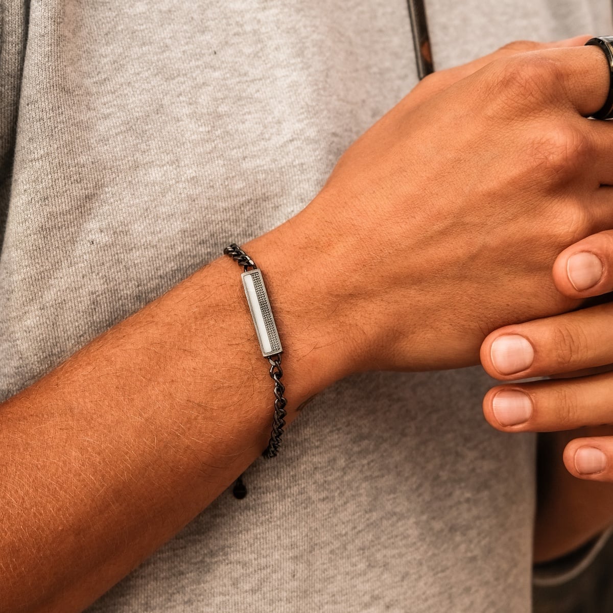 "Planarity Bracelet", a stylish bracelet, features a marble and dark grey design.