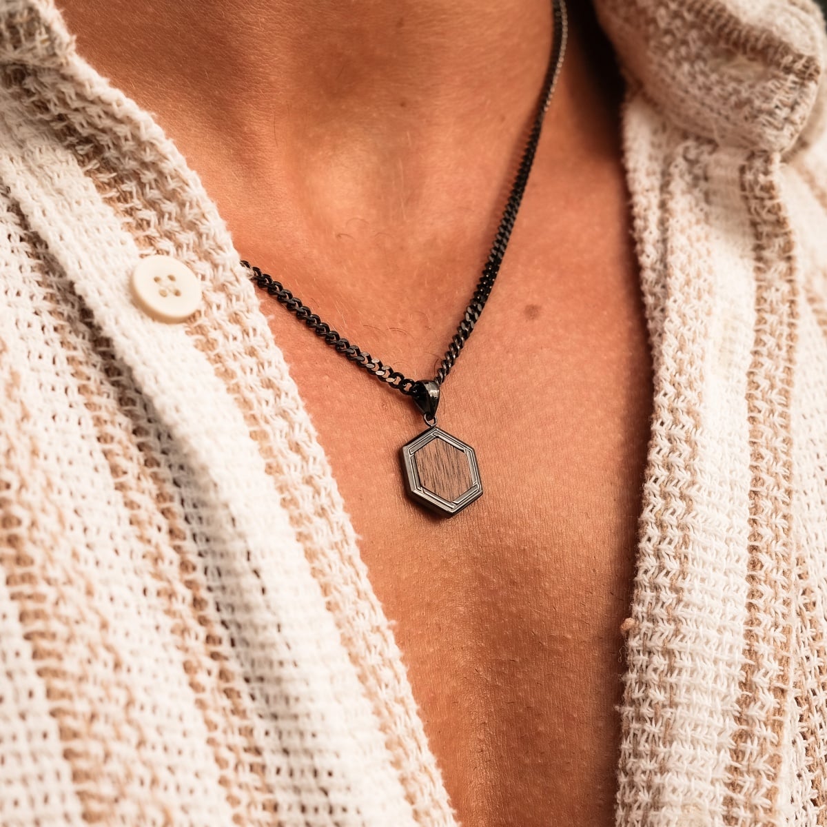 "Axis Necklace", a stylish walnut and dark gray hexagonal pendant necklace, adds a touch of elegance to any outfit.
