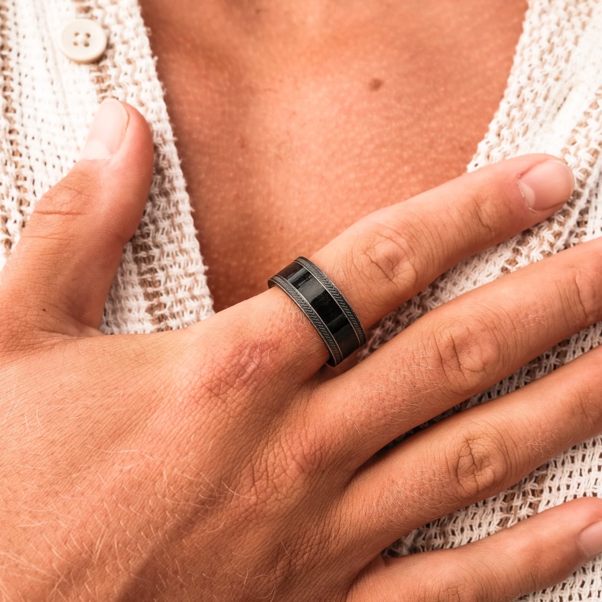 "Countless Ring" ring featuring a sleek maple and antique silver design worn on a hand.