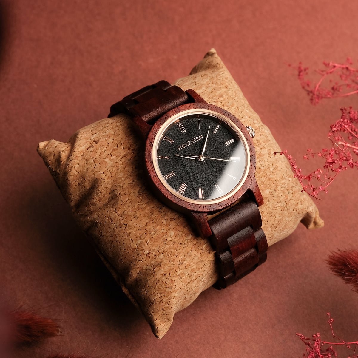 "Passion" watch with a Padauk and Maple design, featuring a wooden band and elegantly dial on a textured cushion background.