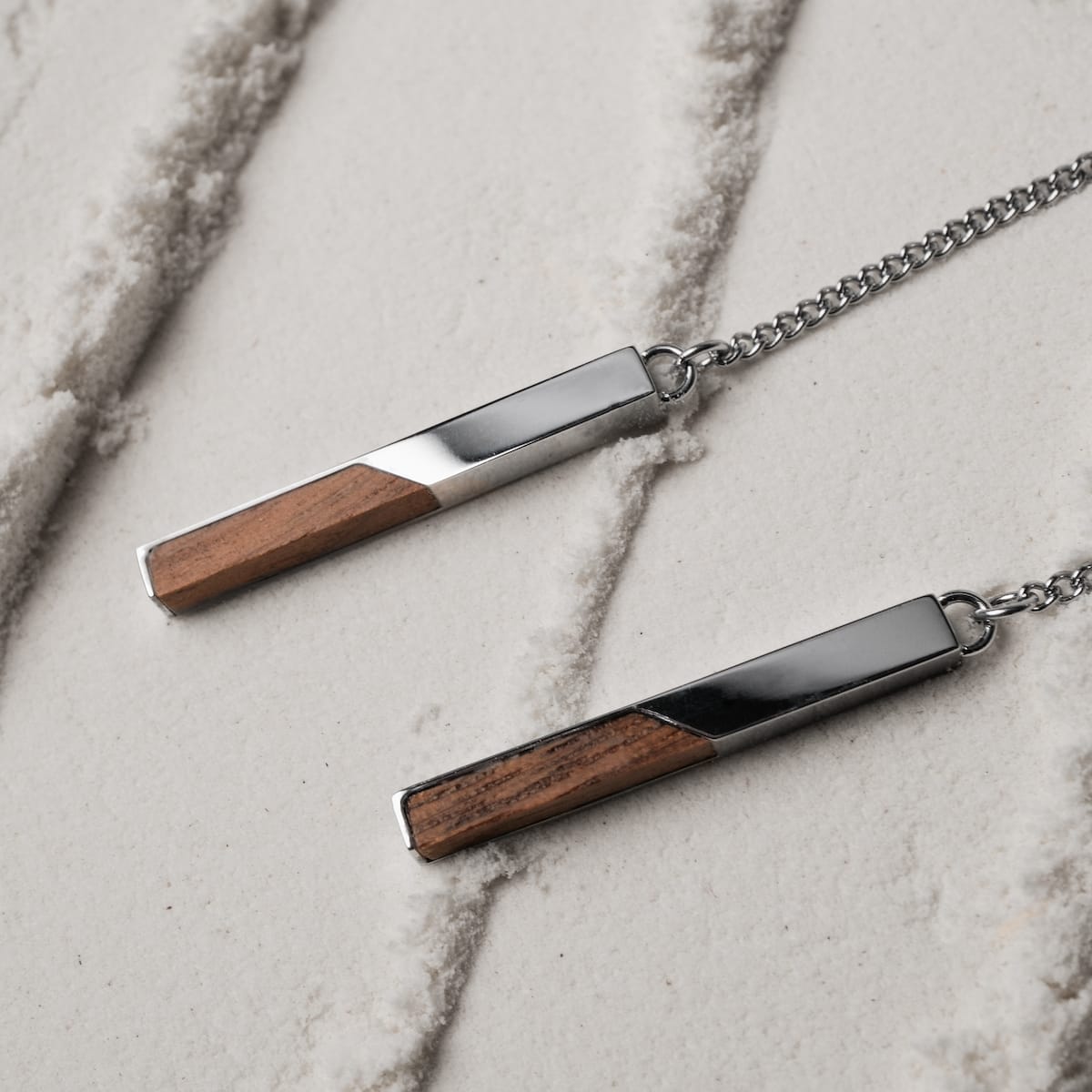 Campania Earrings feature a sleek walnut and silver design with a modern, minimalist style.