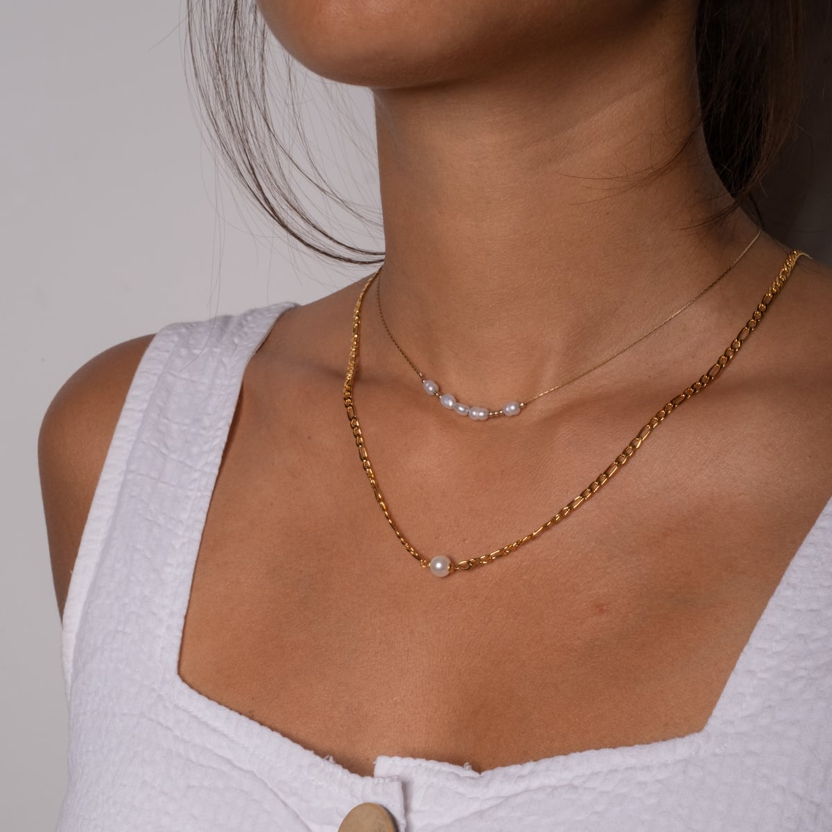 "Jewelry Extender", gold jewelry extender, enhances necklace length, shown in elegant layered style.