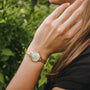 "Themis" watch features nacre dial with gold accents, offering a luxurious and elegant style.