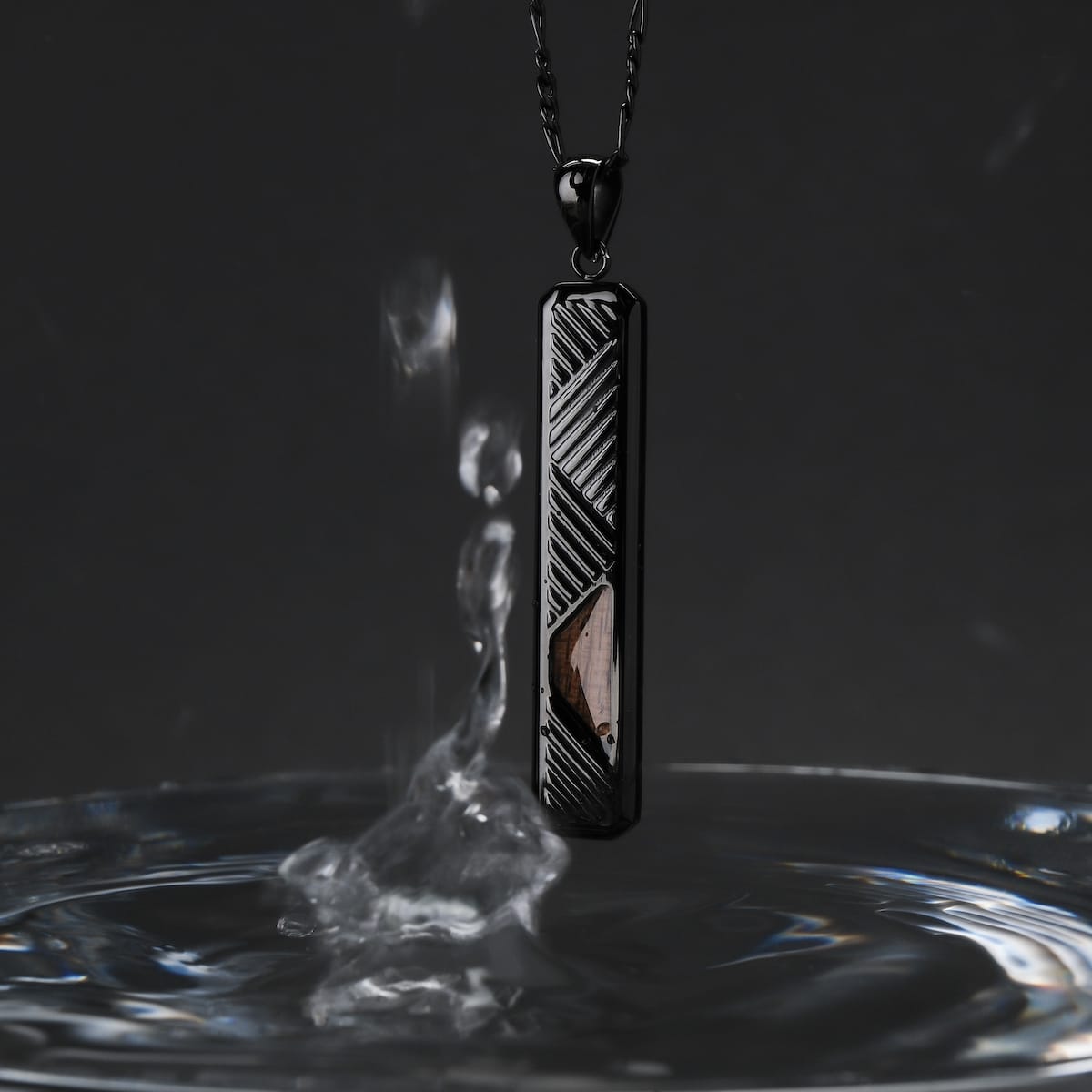 "Derivatives Necklace" necklace features a sleek rectangular design in Zebrawood and black, with a modern, elegant style.