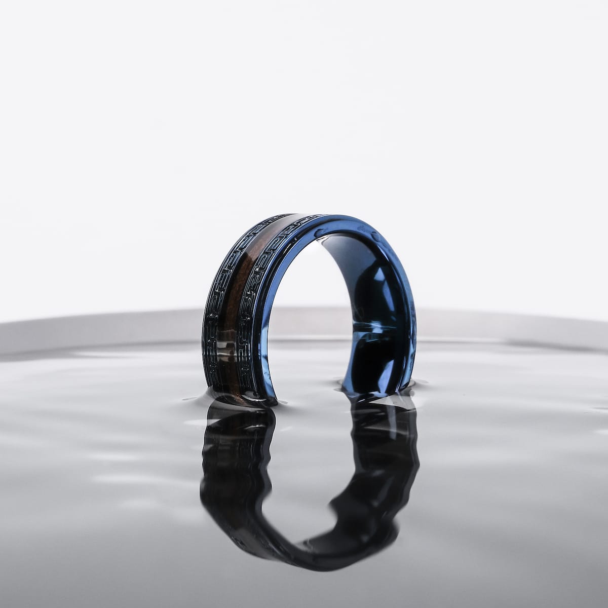 Numerary Ring is a stylish walnut and blue ring with a sleek, modern design.