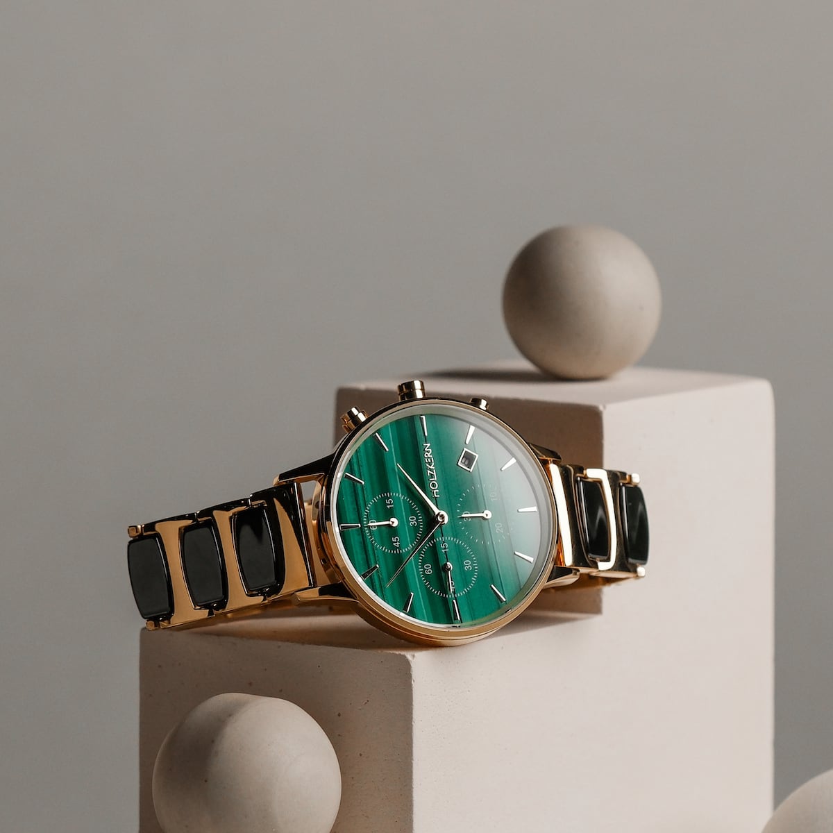 "Jolly" watch, featuring a malachite face and ceramic accents, exudes modern elegance in a sleek design.