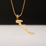 "Believe-Charm", a gold charm necklace featuring a pearl accent, elegantly cursive design.