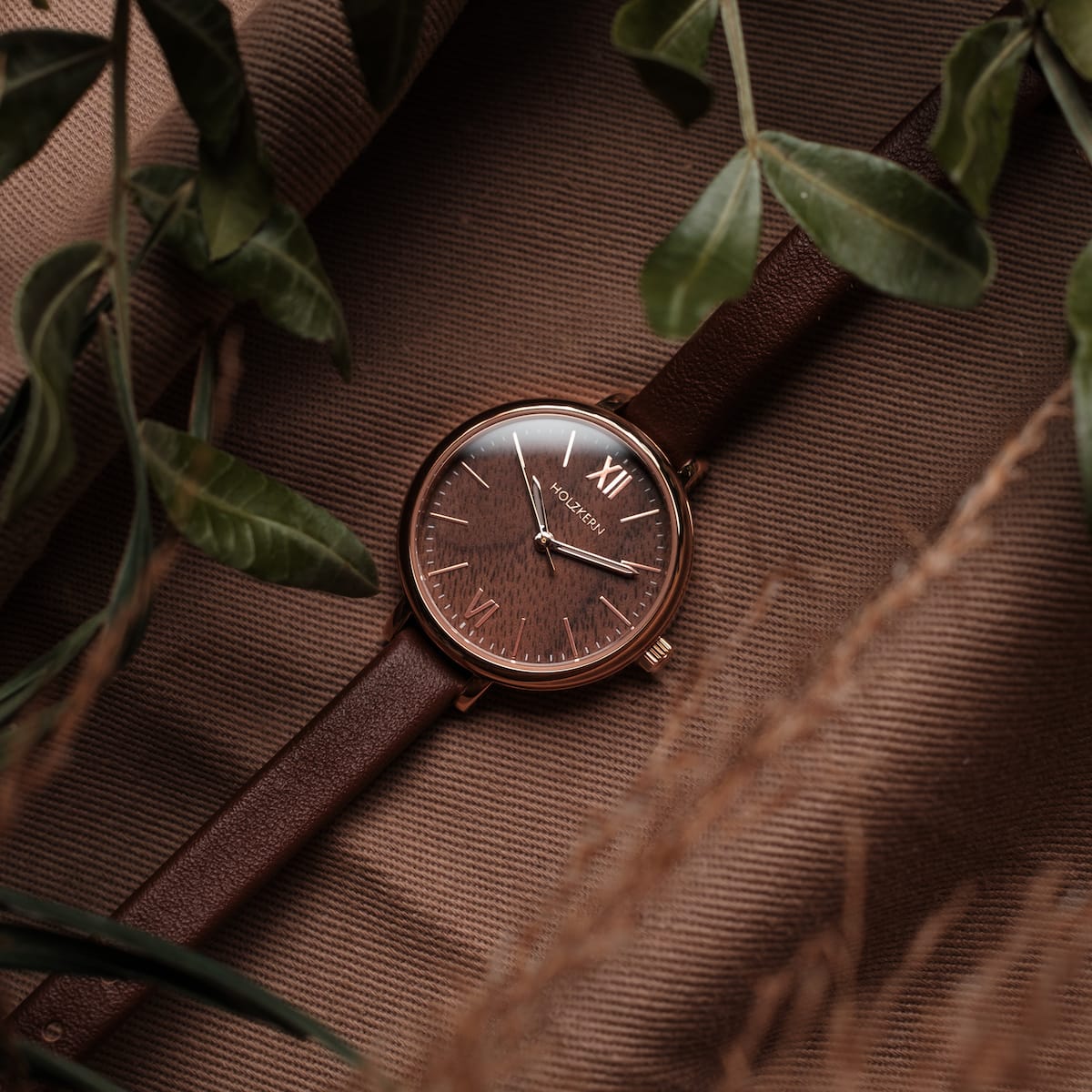 "Shirin" watch with walnut dial and rose gold accents, featuring a classic and elegant design.